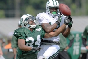 Dimitri Patterson breaks up a pass to Jacoby Ford at practice.