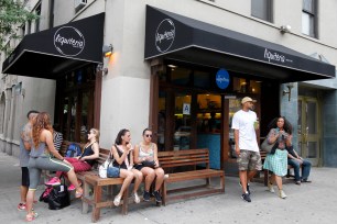 New Yorkers sit and sip their fresh juices outside of Liquiteria in the East Village.