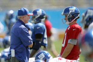 Tom Coughlin and Eli Manning chat during practice in East Rutherford on Tuesday.