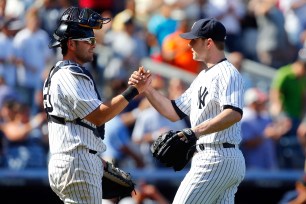 David Robertson and Francisco Cervelli celebrate after finishing off the Tigers on Thursday.