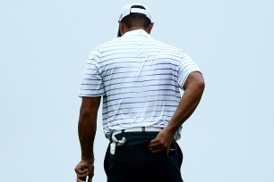 Tiger Woods rubs his lower back between shots at he PGA Championship last week.