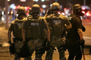 Police advance on demonstrators in Ferguson, Mo., protesting the killing of Michael Brown.