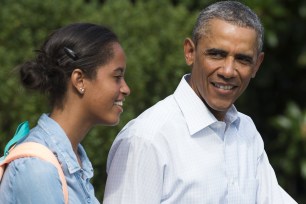 US President Barack Obama and his daughter Malia walk to Marine One prior to departing from the South Lawn of the White House in Washington, DC, August 19, 2014. Obama returns to Martha's Vineyard, Massachusetts to continue his summer family vacation following a 2-day return to Washington for meetings after spending last week on the island. AFP PHOTO / Saul LOEB (Photo credit should read SAUL LOEB/AFP/Getty Images)