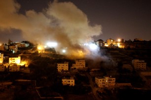 Smoke billows above the West Bank town of Hebron early on August 18th.