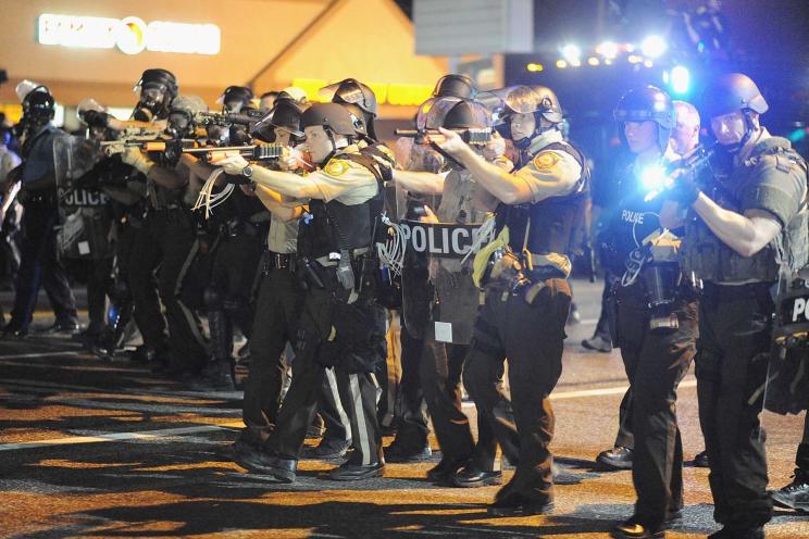 Law enforcement officers watch on during a protest on West Florissant Avenue in Ferguson on Aug. 18.