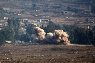 Smoke billows from a Syrian village following an explosion during fighting on August 31, 2014.