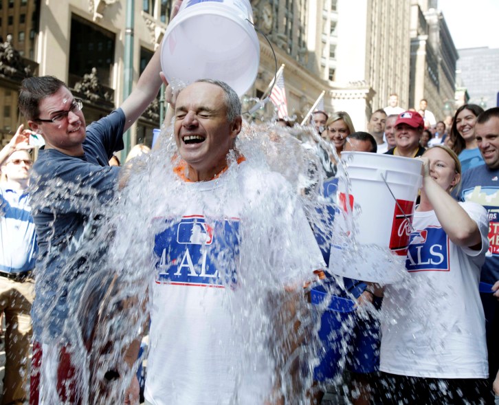 Major League Baseball Commissioner-elect Rob Manfred participates in the ALS Ice-Bucket Challenge outside the organization's headquarters in New York, Wednesday, Aug. 20, 2014. Manfred participated with more than 160 other MLB employees to raise more than $16,000 for the ALS Association. (AP Photo/Vanessa A. Alvarez)