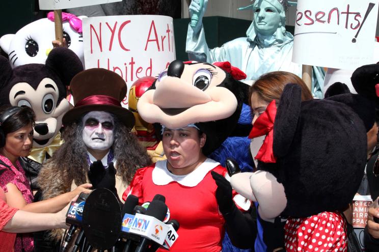 Jovana Melendez, dressed in a Minnie Mouse costume, speaks at a press conference in Times Square.