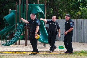 Police investigate the scene of the stabbing.