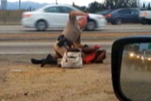 In a video still, California Highway Patrol officer Daniel Andrew punches Marlene Pinnock, 51, on the shoulder of a Los Angeles freeway on July 1.