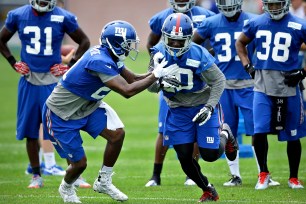 Dominique Rodgers-Cromartie and Prince Amukamara run a drill at Giants training camp.