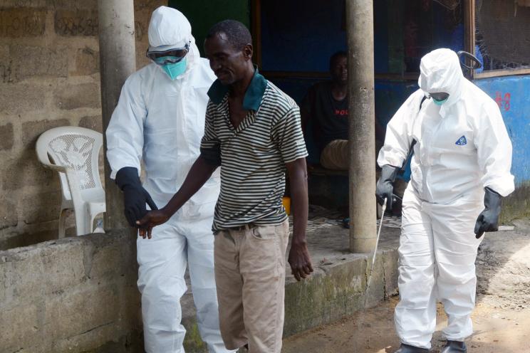 Nurses in Monrovia, Liberia escort an Ebola patient to the hospital on August 25.