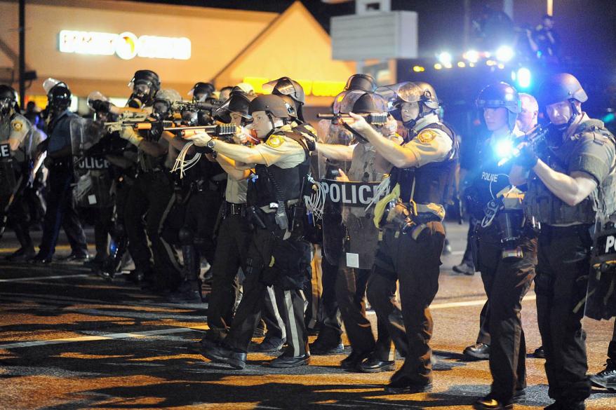 Law enforcement officers watch on during a protest on West Florissant Avenue in Ferguson, Missouri on August 18, 2014.