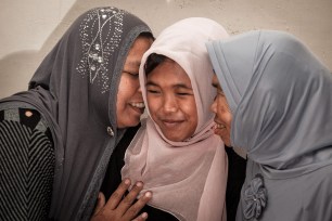 Jamaliah (left) gives a hug to her daughter Raudhatul Jannah (center) after being reunited in Meulaboh, Aceh, northern Sumatra, Indonesia on August 7.