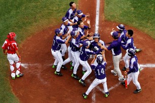 South Korea's team celebrates at home plate after Hae Chan Choi, center, knocked a home run in the second inning of the international semifinal.