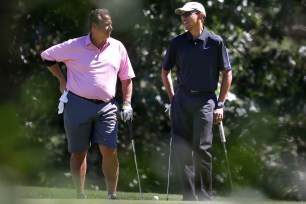 President Obama chats up golf partner Robert Wolf during a round in Oak Bluffs, Mass. in August. Wolf will host the Labor Day barbecue that will give Wall Street financiers the chance to bend Obama's ear.