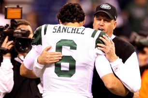 Mark Sanchez and Rex Ryan embrace after the Jets beat the Colts in a 2011 wild-card game.
