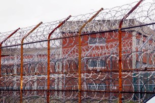 A security fence surrounds the inmate housing on Rikers Island.