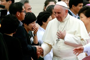 DAEJEON, South Korea (AP) — Tens of thousands of Asian Catholics gave a boisterous welcome to Pope Francis on Friday as he celebrated his first public Mass in South Korea, a country with a small but growing church that is seen by the Vatican as a model for the rest of the world. Francis took a high-speed train to the central city of Daejeon, where Catholic youths from across Asia have been meeting for the Asian version of World Youth Day. Francis celebrated Mass in Daejeon's soccer stadium, which has a capacity of 50,000 and was nearly full hours before Francis arrived. Handkerchief-waving crowds led in chants of "Viva il papa!" welcomed him as his open-sided vehicle, with a simple canopy overhead, made its way slowly to the stadium and then inside. Before Mass got under way, Francis met with about a dozen survivors of South Korea's ferry disaster and relatives of the dead who are demanding a government inquiry into the sinking. Most of the more than 300 people killed were high school students on a class trip. Their relatives are pushing lawmakers to set up an independent, transparent probe of the cause of the sinking. The ruling party is opposed because it says a parliamentary committee doesn't have the power to indict. The Vatican spokesman, the Rev. Federico Lombardi, has said Francis wouldn't intervene in the issue but would merely offer comfort to the families. A banner outside the stadium featured a photo of the pope and read "Please wipe the tears of the Sewol families." Lombardi didn't provide details of the content of the meeting, saying only that Francis met with about a dozen people in a room of the stadium before Mass began. After Mass, Francis was to eat lunch with some of the youth festival participants and then visit an 18th century sanctuary where Korea's first priest was raised. South Korean Catholics represent only about 10 percent of the country's 50 million people, but their numbers are growing. Once a country that welcomed missionaries, South Korea now sends homegrown priests and nuns abroad to help spread the faith.