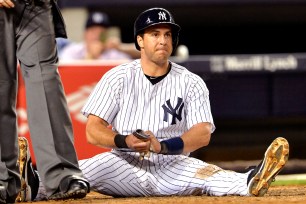 Mark Teixeira grabs his pinkie after sliding into home.