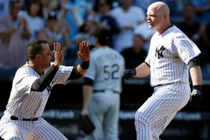 Martin Prado meets Brian McCann at home plate after McCann's walk-off on Sunday afternoon to secure a Yankees sweep of the White Sox.