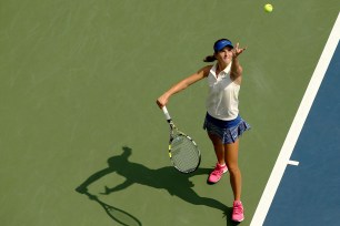 Cici Bellis serves to Renata Zarazua on Monday during their juniors match.