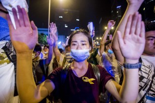 A demonstrator gestures opposite policemen during a pro-democracy in Hong Kong.