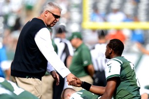 Rex Ryan talks with Geno Smith before the loss to the Lions.