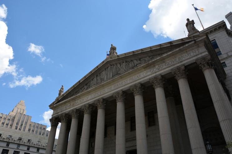 In addition to allegedly paying a court staffer to send cases their way, three lawyers also have a reputation of skulking outside the arraignment room in Manhattan Criminal Court (pictured) to solicit potential clients.