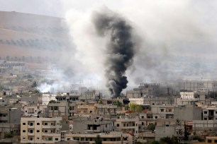 Smoke rises from the Syrian town of Kobani after US-led coalition airstrikes on October 12.