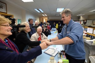 Republican U.S. Senate candidate Scott Brown shakes hands with diners at Mackenna's Restaurant on Nov. 3 in New London, New Hampshire.