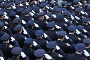 Police salute at the funeral of New York Police Officer Wenjian Liu on Sunday.