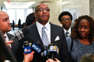 Michael Waithe (center) speaks to the press along side his fiancée Karen Garrick (right) after he has his 1986 burglar conviction overturned at Brooklyn Supreme Court.