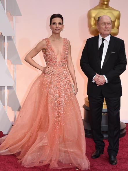 Nominee for Best Supporting Actor Robert Duvall arrives with wife Luciana Pedraza on the red carpet for the 87th Oscars February 22, 2015 in Hollywood, California. AFP PHOTO / MARK RALSTON (Photo credit should read MARK RALSTON/AFP/Getty Images)