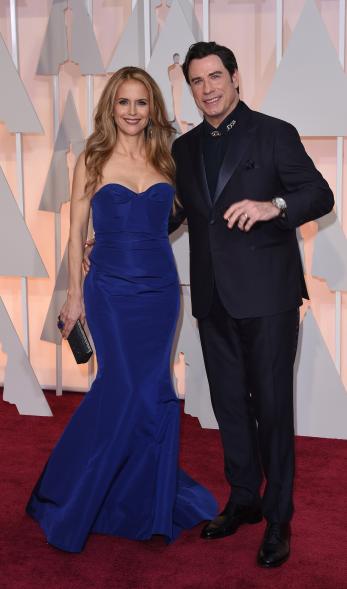 Actor John Travolta arrives with wife Kelly Preston on the red carpet for the 87th Oscars February 22, 2015 in Hollywood, California. AFP PHOTO / MARK RALSTON (Photo credit should read MARK RALSTON/AFP/Getty Images)