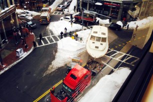 A large truck towing a yacht broke down in the middle of snow-clogged downtown Boston on Wednesday, causing massive traffic delays.