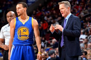 Stephen Curry talks with Warriors coach Steve Kerr.