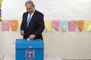 Benjamin Netanyahu casts his vote during Israel's parliamentary elections in Jerusalem on March 17.