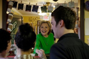 Hillary Clinton shakes hands with residents in a LeClaire, Iowa, coffee house.