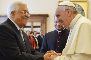 Pope Francis shakes hands with Palestinian authority President Mahmud Abbas on May 16.