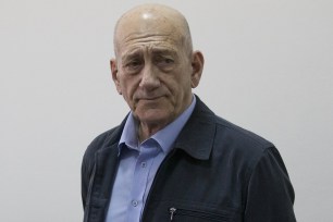 Former Israeli Prime Minister Ehud Olmert stands in court on March 30.