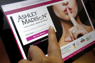 A user in Ottawa logs into the Ashley Madison website using an iPad on July 21.