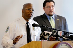 Andre Anderson speaks along side Ferguson Mayor James Knowles III (right) during a news conference on July 22.