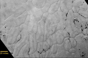A new close-up image from the heart-shaped feature on the surface of Pluto that reveals a vast, craterless plain.