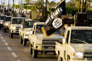 ISIS militants parade through Sirte, Libya in February.