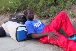 Loah Linares sleeps on the street outside Dodger Stadium, waiting for a tryout with the team.