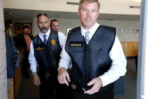 Investigators exit Palm Springs City Hall during a raid in Palm Springs, California on Sept. 1.