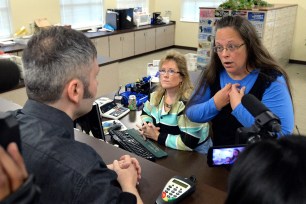 Rowan County Clerk Kim Davis, right, talks with David Moore following her office's refusal to issue marriage licenses in Morehead, Ky. on Sept. 1.