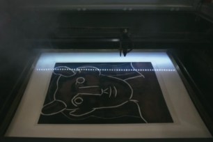 Picasso's Tête de Faune under a laser.