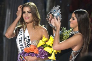 The crown is removed from Miss Colombia Ariadna Gutierrez (left) by Miss Universe 2014 Paulina Vega after the pageant's host misread the card stating the winner of the 2015 Miss Universe show.